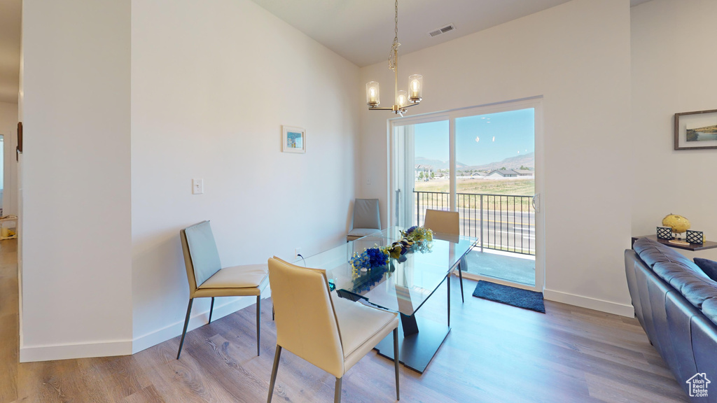 Dining area featuring an inviting chandelier and light hardwood / wood-style flooring