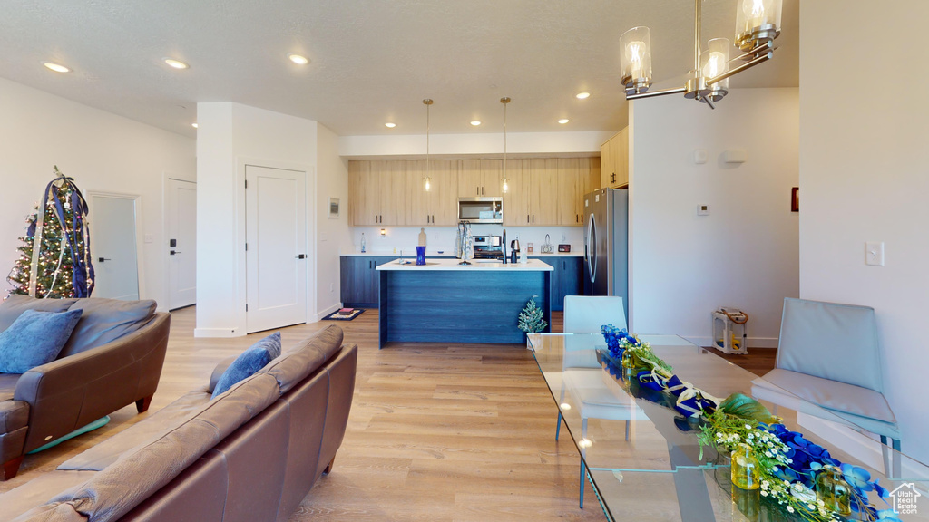 Living room featuring a chandelier and light hardwood / wood-style flooring