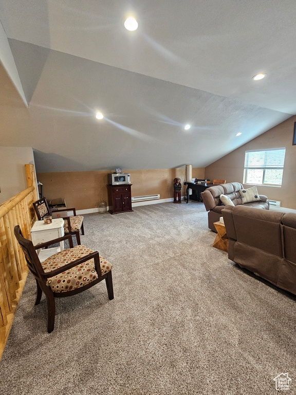 Interior space with vaulted ceiling, a baseboard radiator, and carpet floors