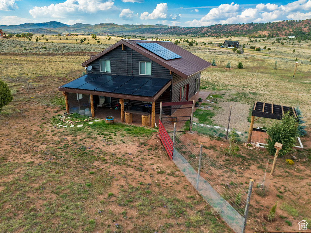 View of front of home featuring a mountain view, a rural view, and an outbuilding