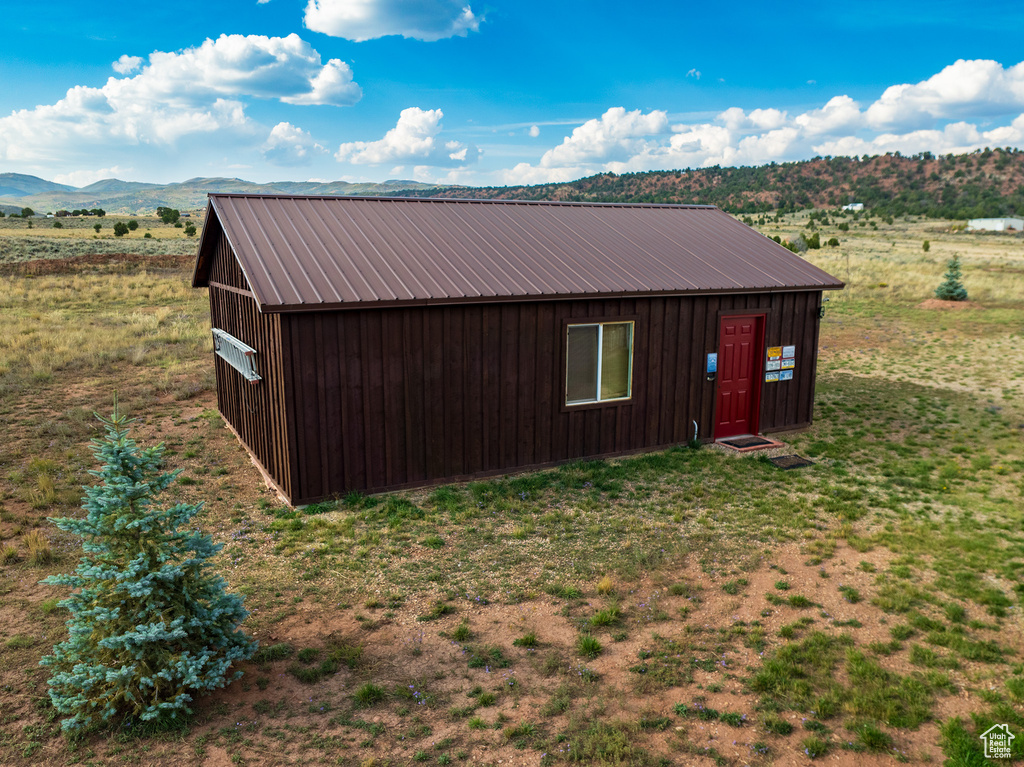 View of outbuilding featuring a mountain view and a rural view