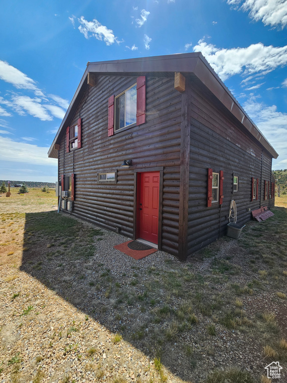 View of property exterior featuring a yard