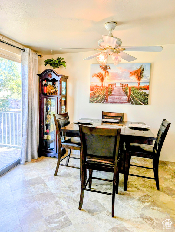 Tiled dining room with ceiling fan