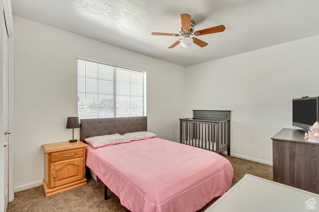 Bedroom with light colored carpet and ceiling fan