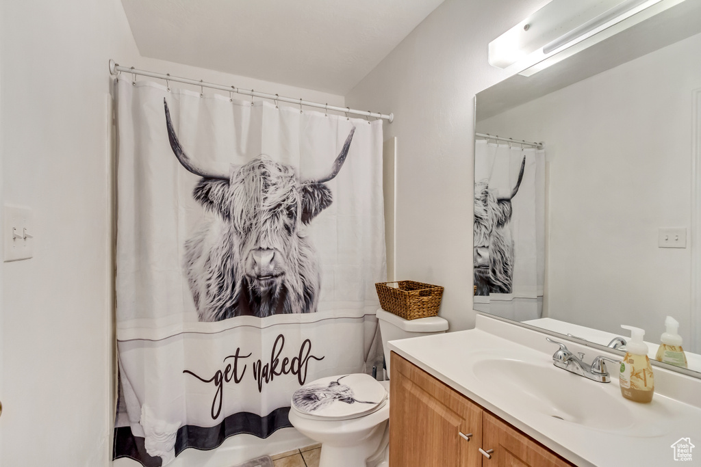 Bathroom with vanity, tile patterned flooring, and toilet