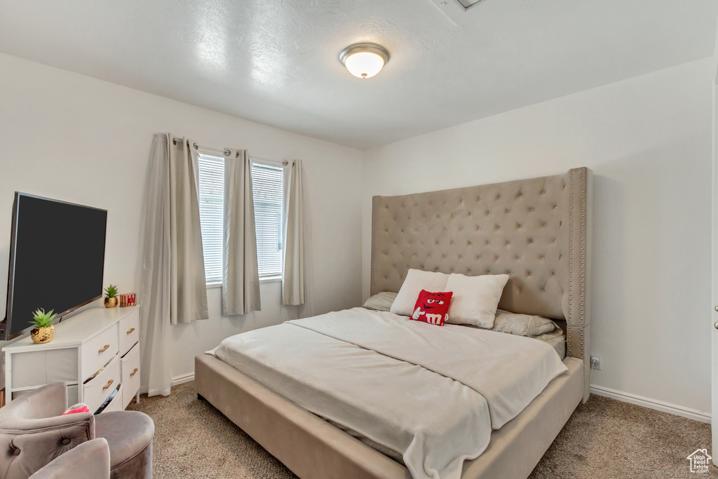 Bedroom featuring light carpet