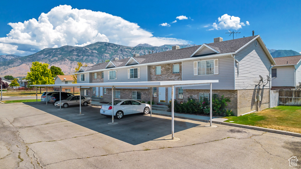 View of front facade featuring a mountain view and a carport