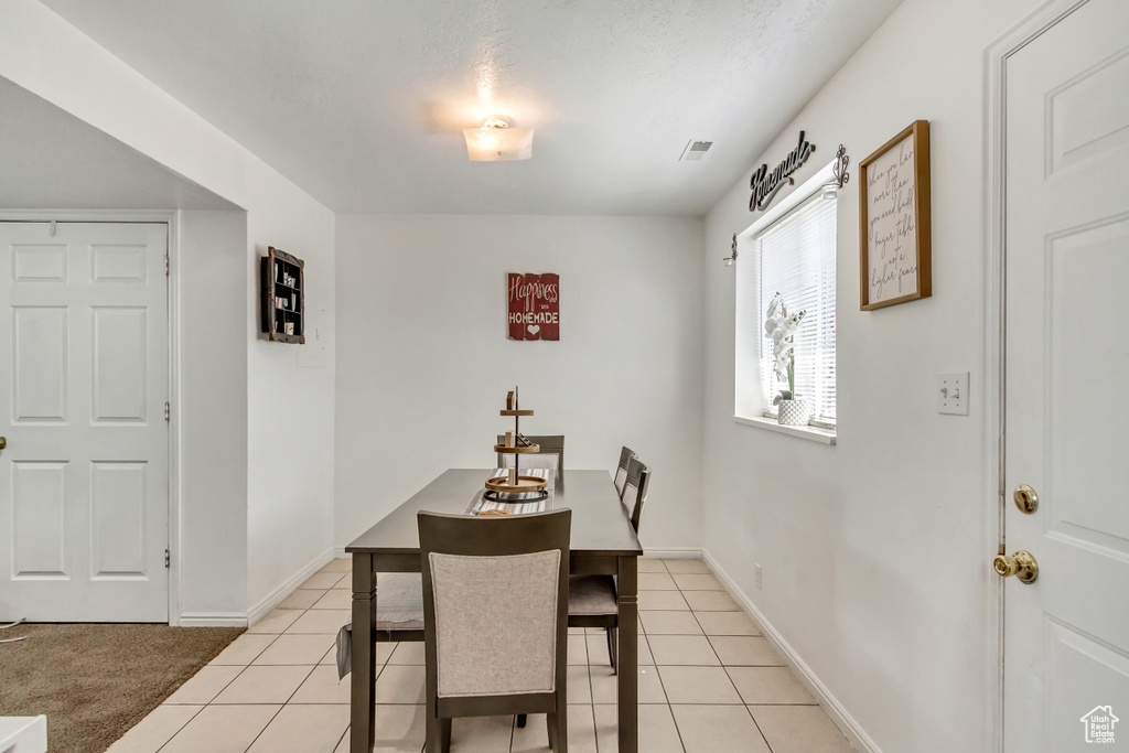 Dining space featuring light colored carpet