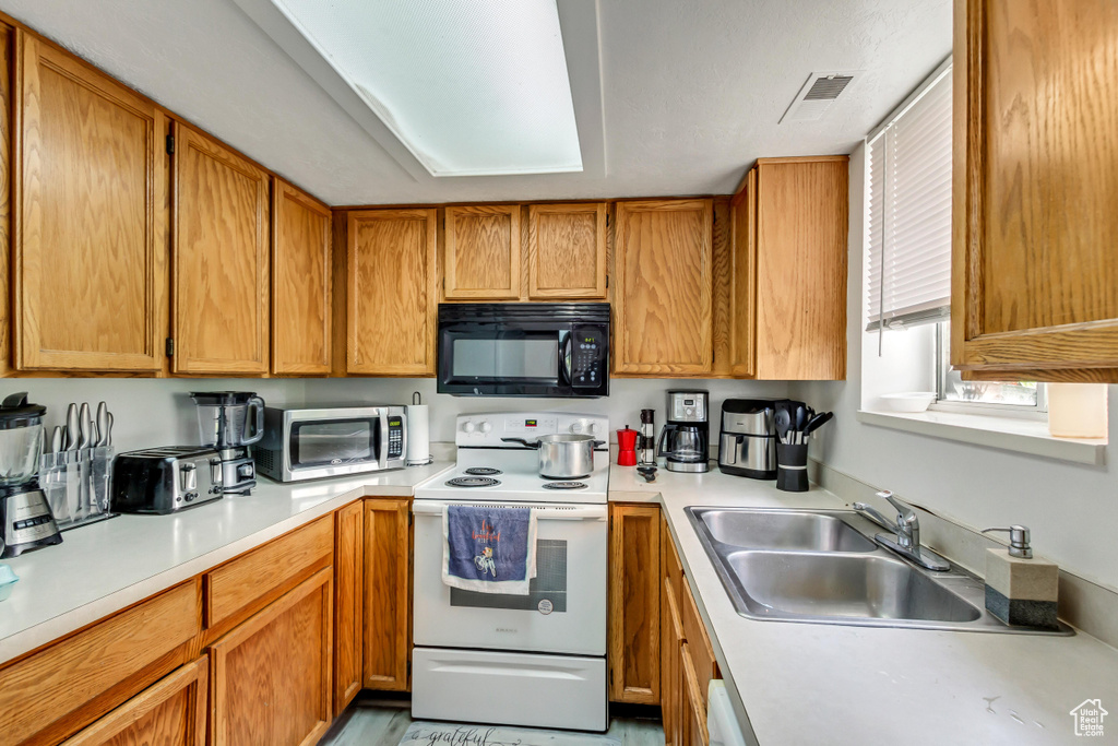 Kitchen with sink and electric stove