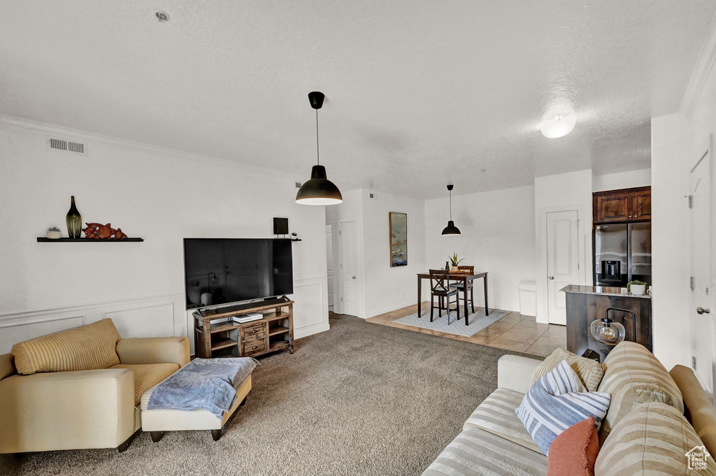 Carpeted living room with ornamental molding