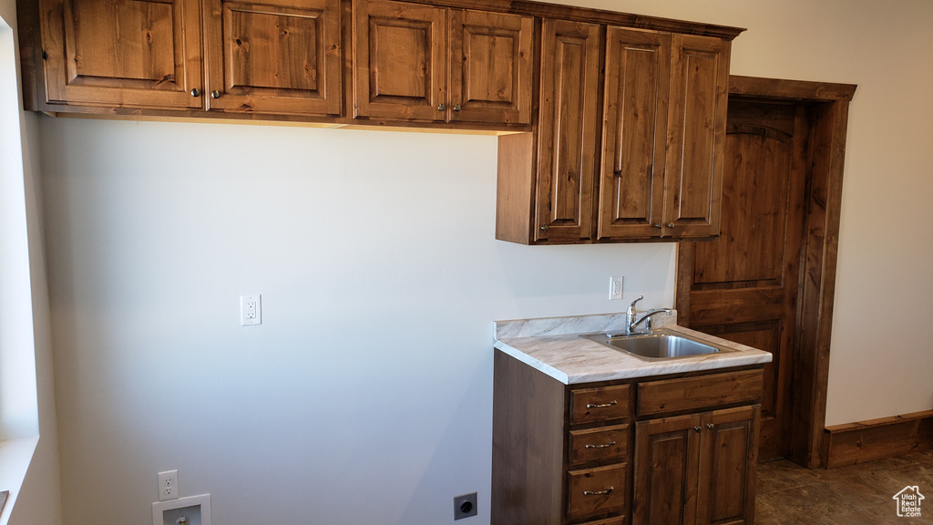 Kitchen with sink and dark tile patterned flooring