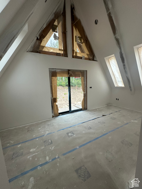 Additional living space featuring high vaulted ceiling