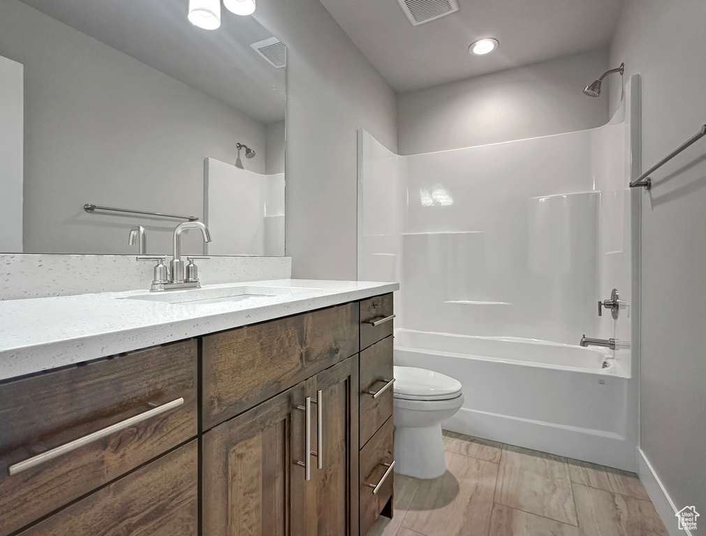 Full bathroom featuring tub / shower combination, vanity, and toilet