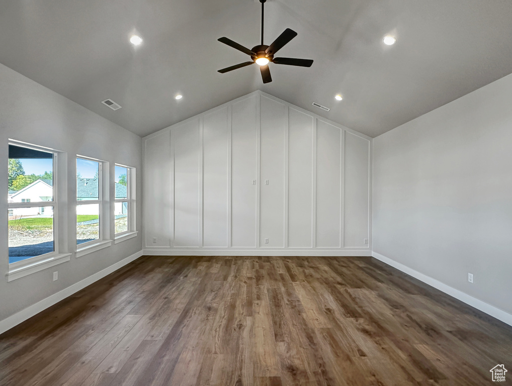 Interior space featuring wood-type flooring, vaulted ceiling, and ceiling fan