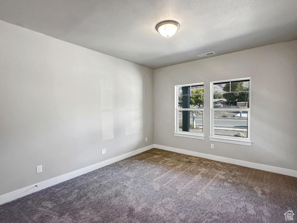 Spare room with carpet floors and a textured ceiling