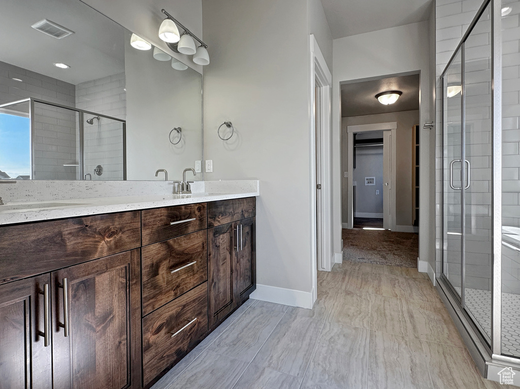 Bathroom featuring an enclosed shower and vanity