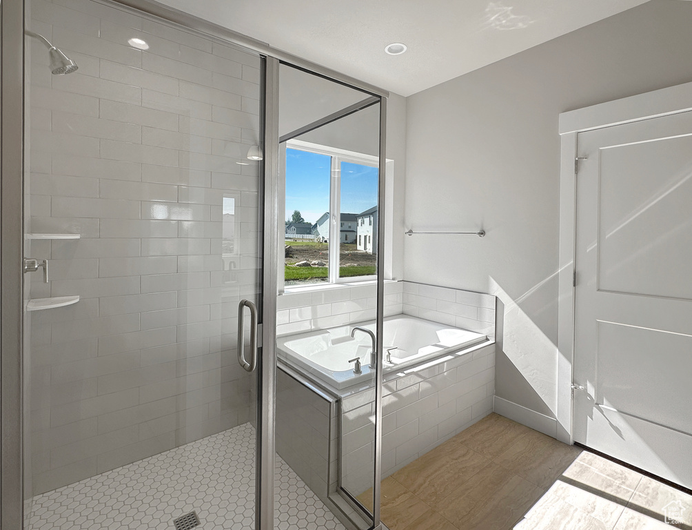 Bathroom with plus walk in shower and hardwood / wood-style floors