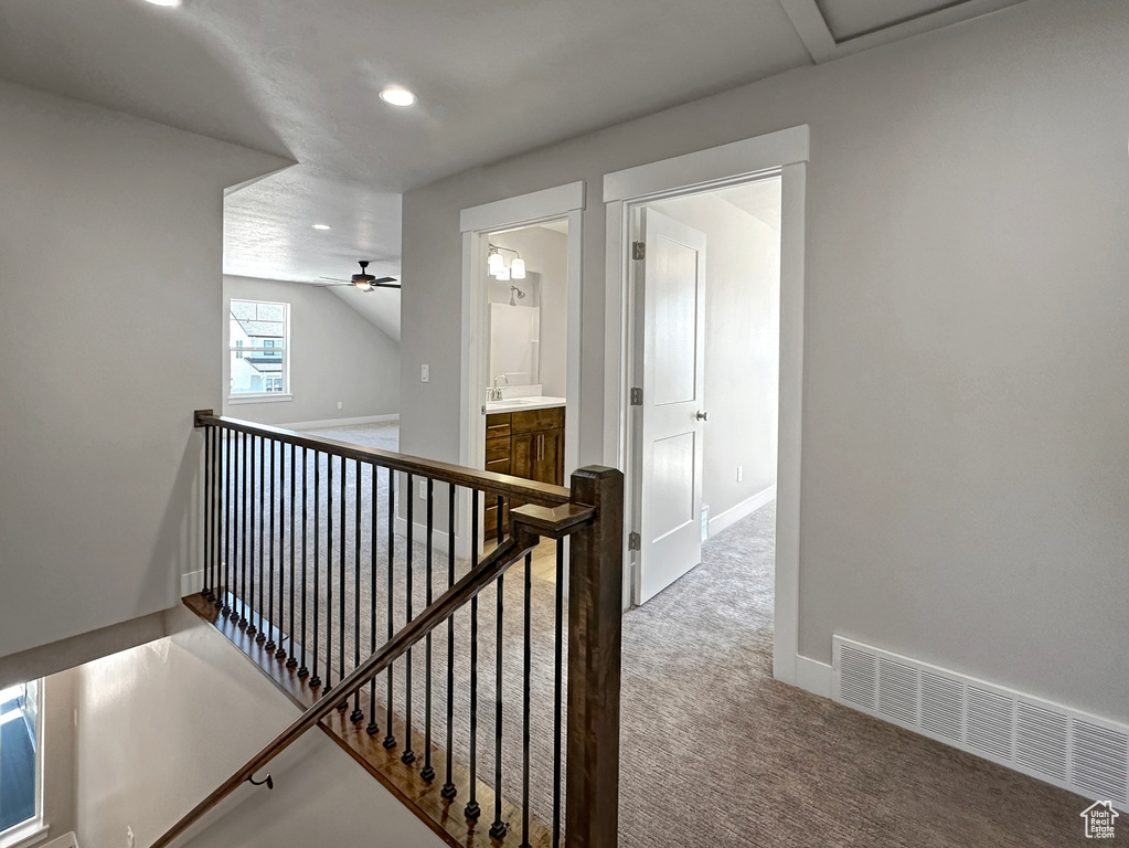 Hallway featuring carpet floors and sink