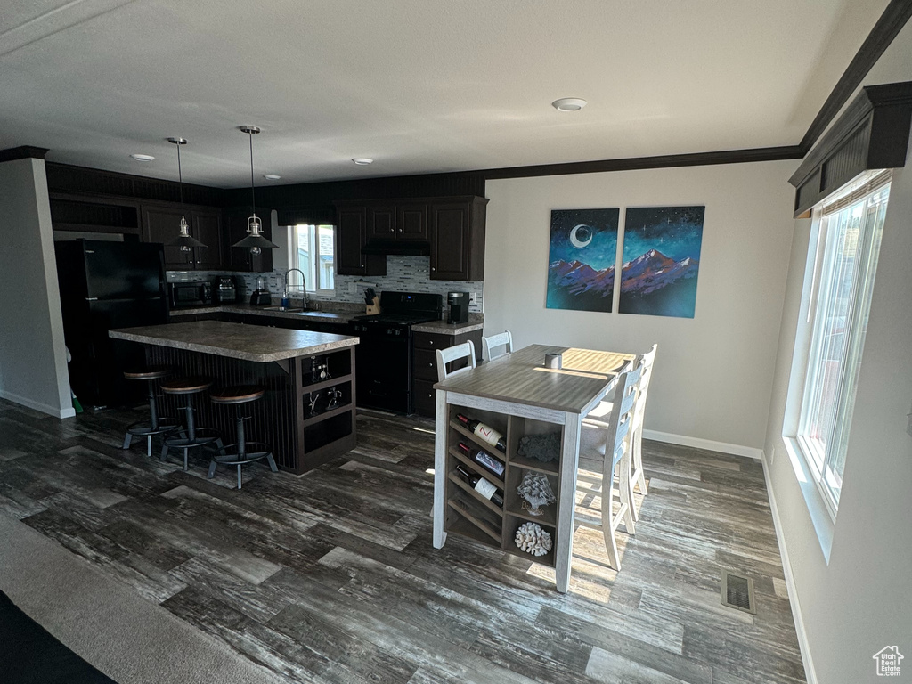 Interior space featuring sink, crown molding, and hardwood / wood-style floors