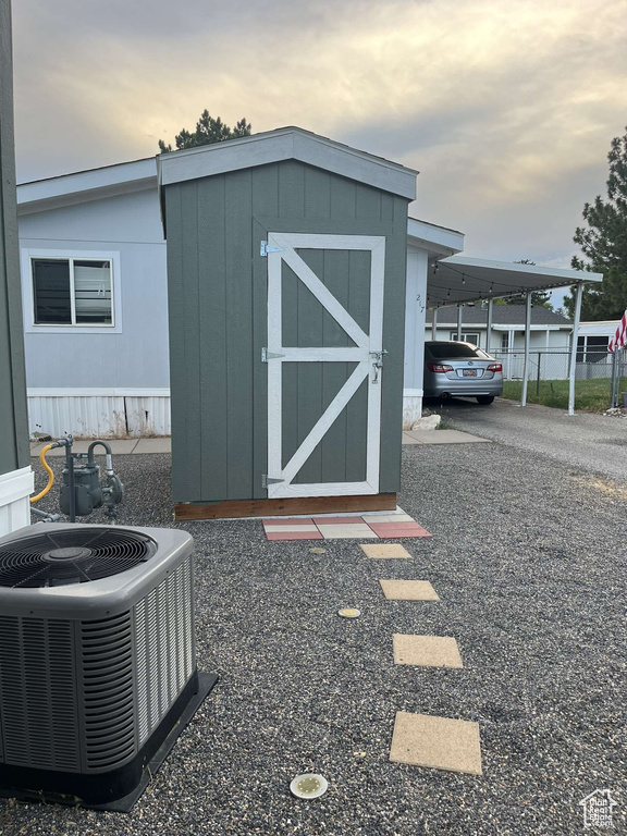 Outdoor structure at dusk with central air condition unit