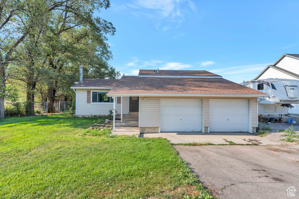 View of front of home featuring a garage and a front lawn