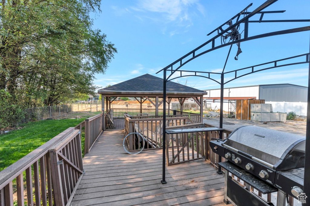 Wooden deck featuring grilling area and a gazebo