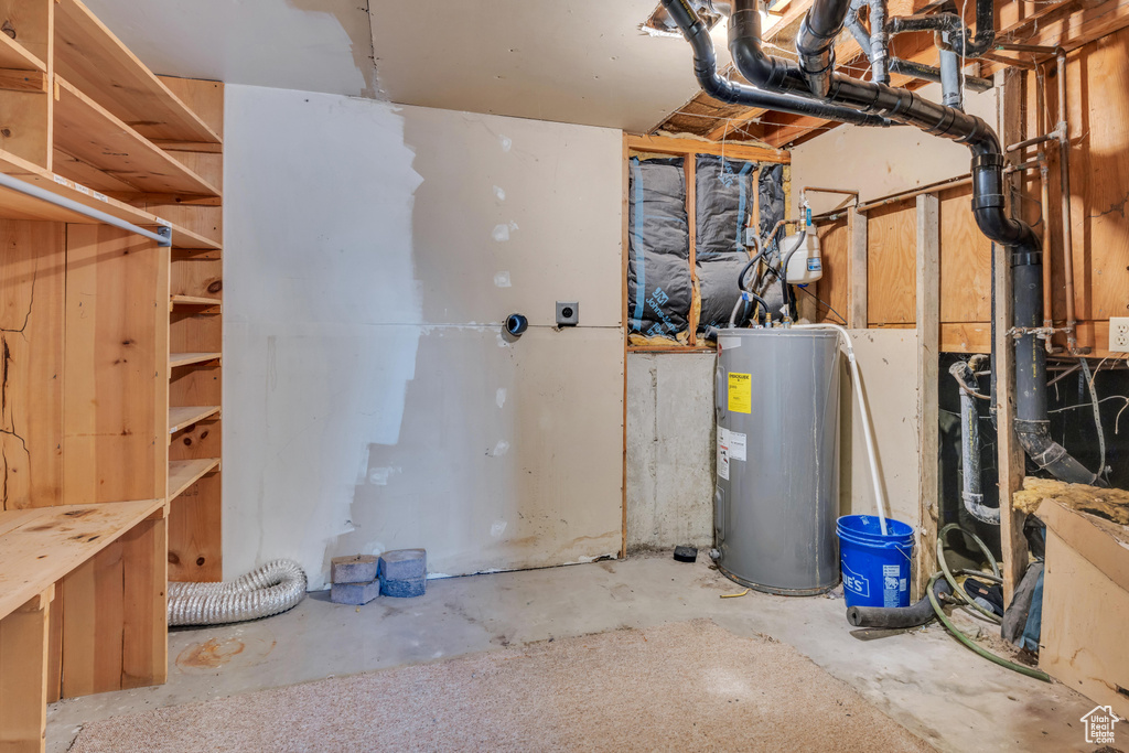 Utility room featuring electric water heater