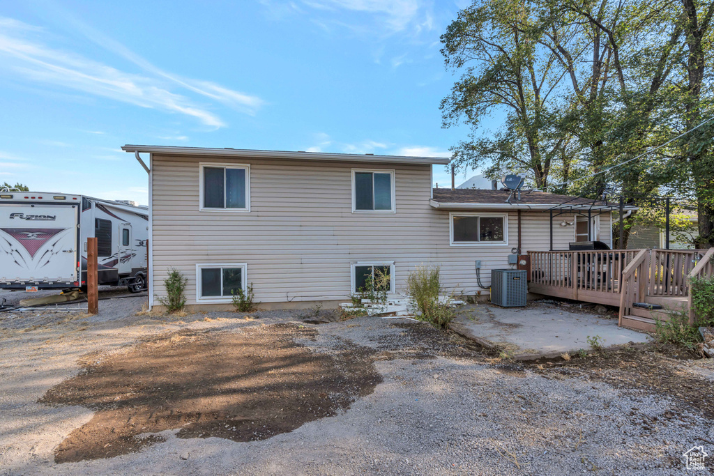 Rear view of property with a deck and central air condition unit