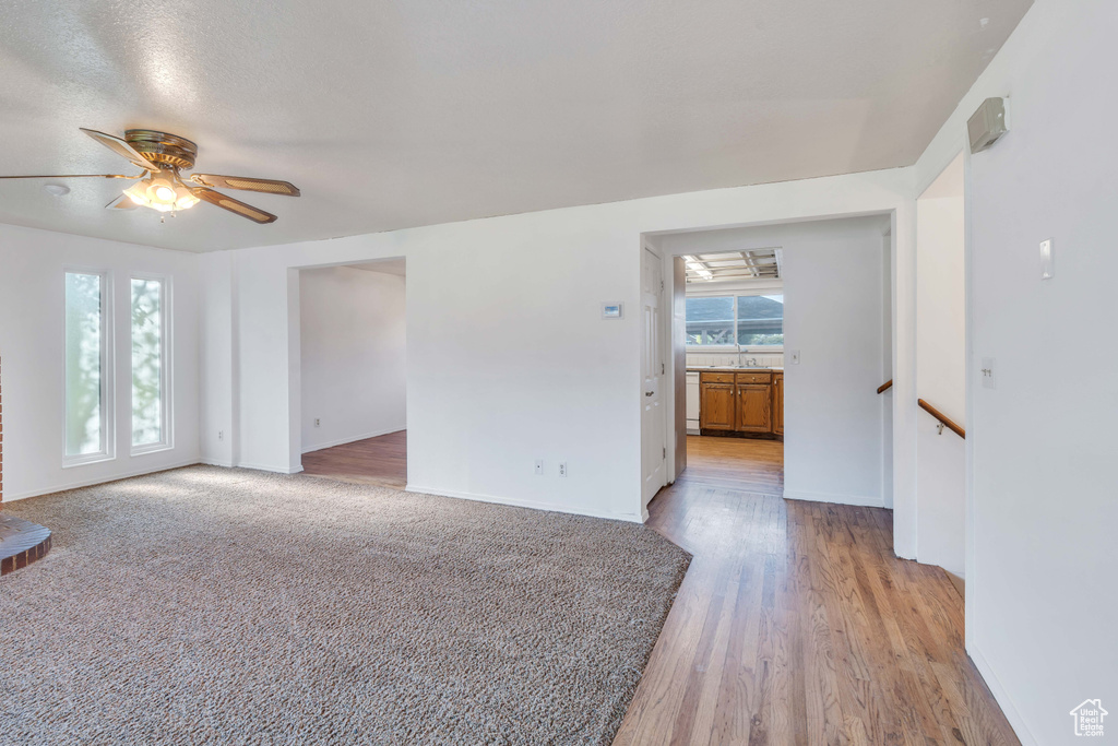 Unfurnished room with light wood-type flooring and ceiling fan