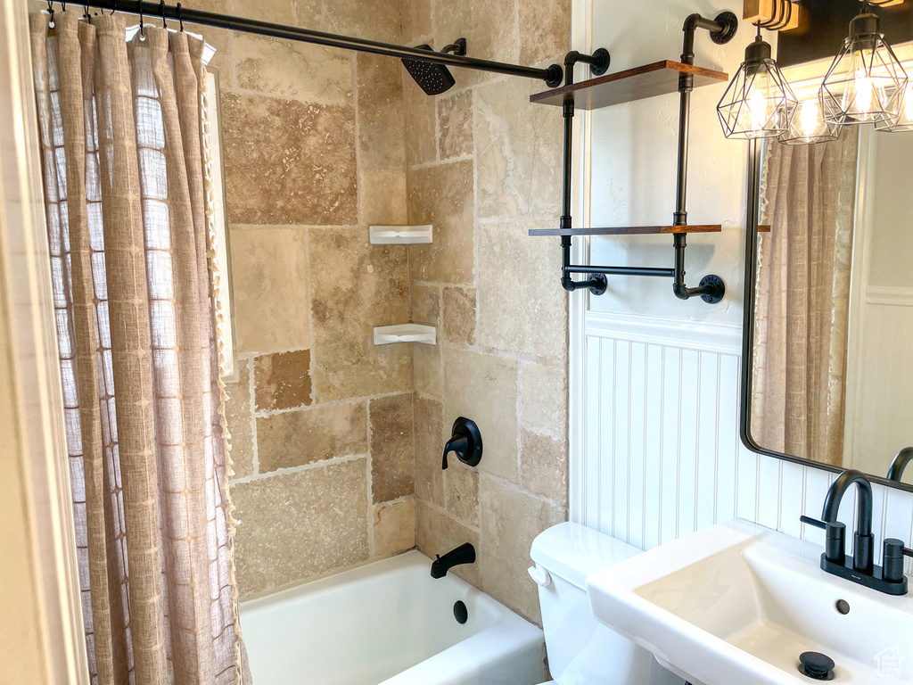 Full bathroom with sink, toilet, and shower / bath combo