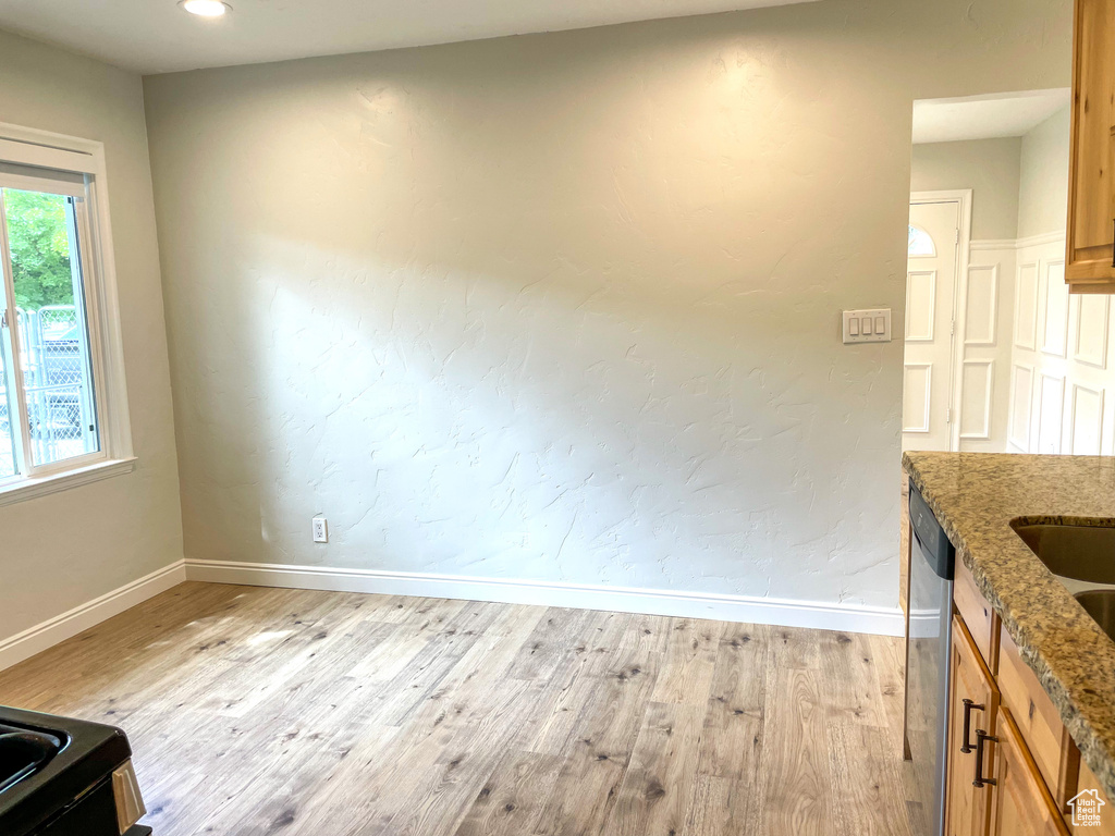 Unfurnished dining area featuring light wood-type flooring