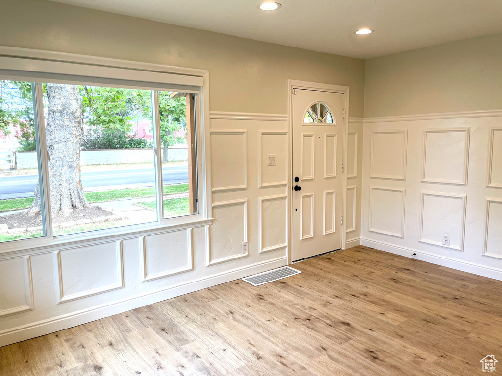 Foyer with light hardwood / wood-style flooring and plenty of natural light