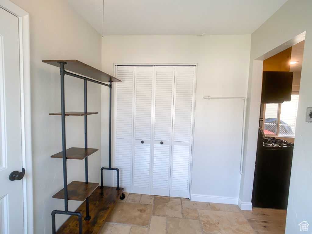 Hall featuring light tile patterned floors