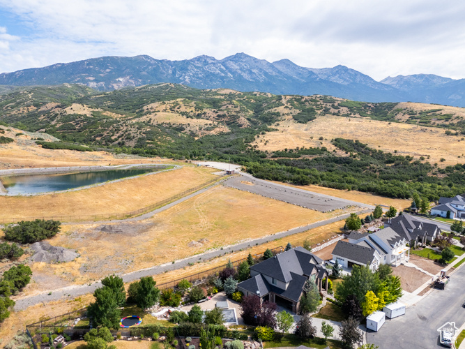 Drone / aerial view featuring a water and mountain view