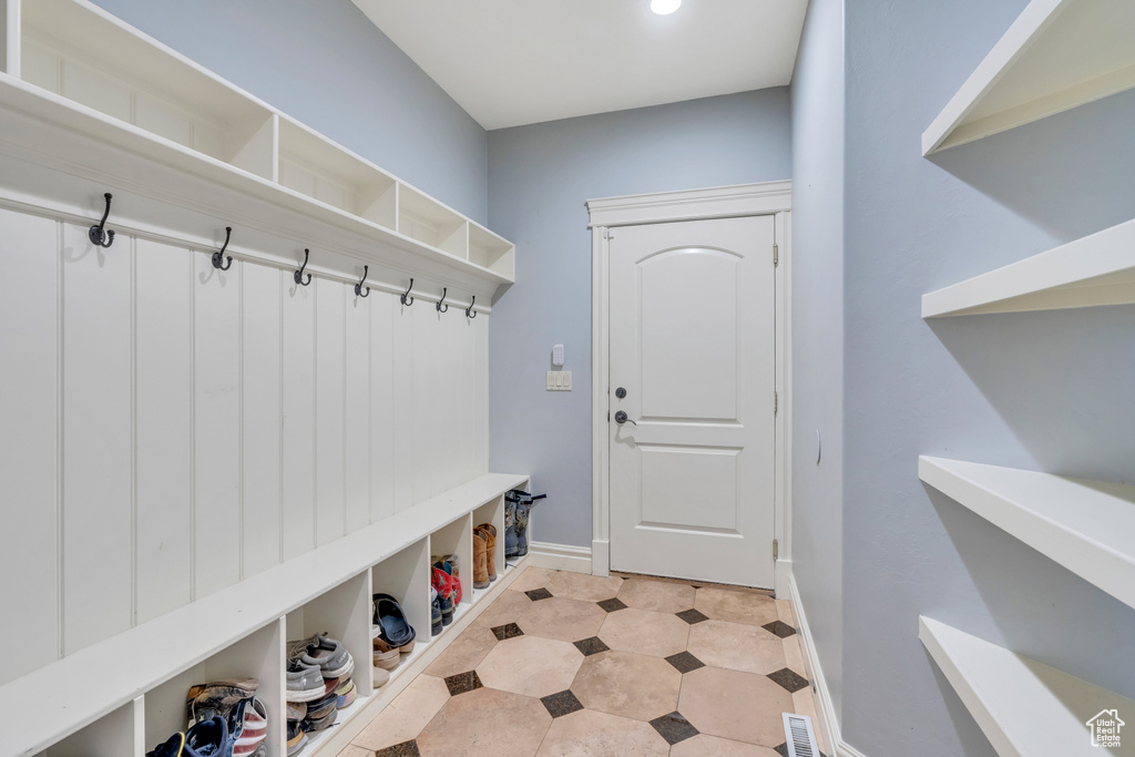 Mudroom with light tile patterned flooring