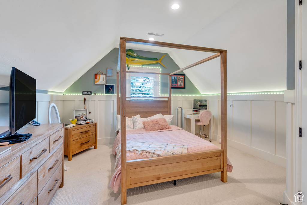 Carpeted bedroom featuring vaulted ceiling