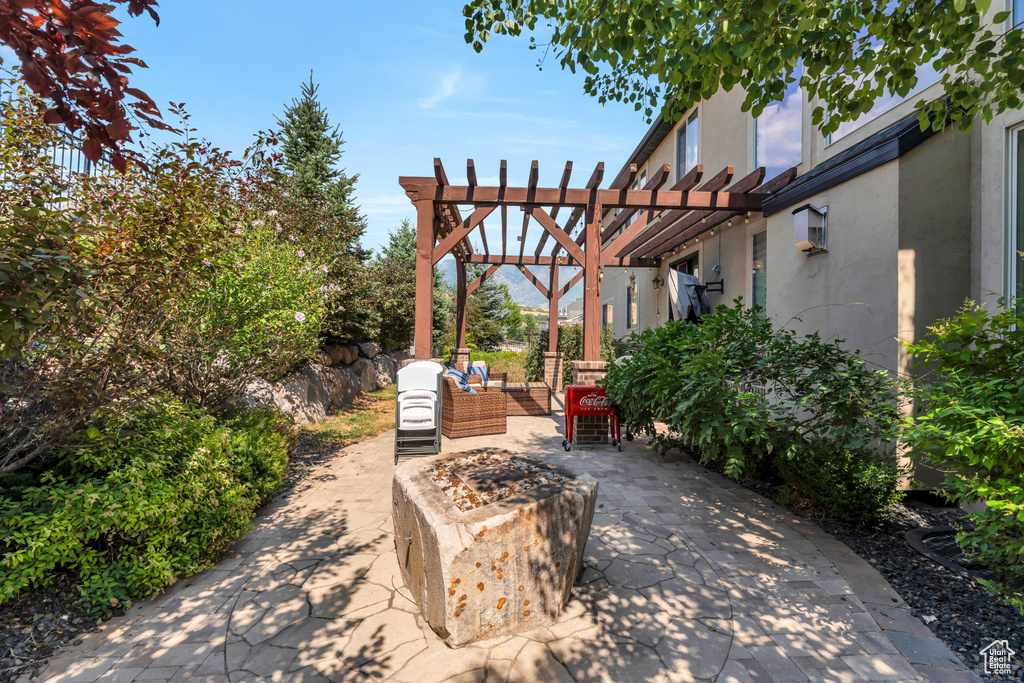 View of patio featuring outdoor lounge area and a pergola