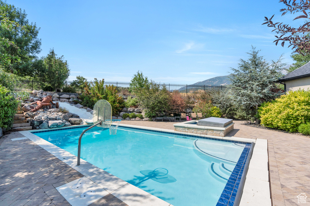 View of pool featuring a mountain view and a patio