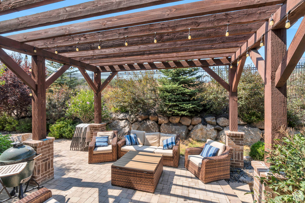 View of patio with an outdoor living space and a pergola