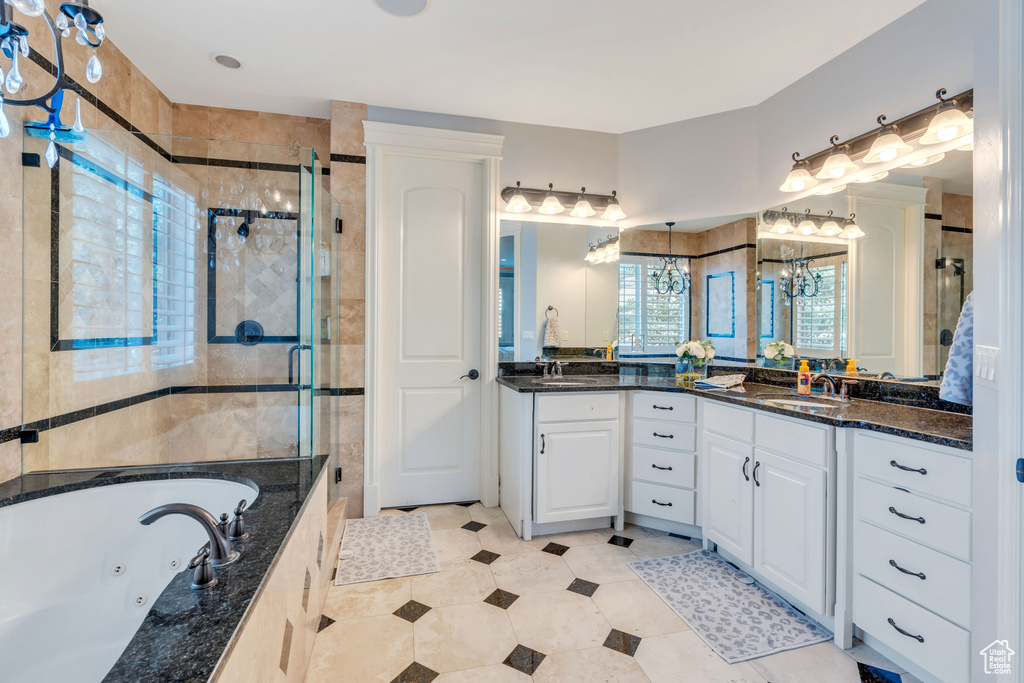 Bathroom featuring tile patterned floors, double sink vanity, and an enclosed shower