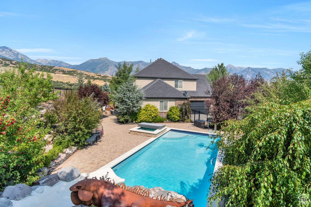 View of swimming pool featuring a mountain view and a patio area