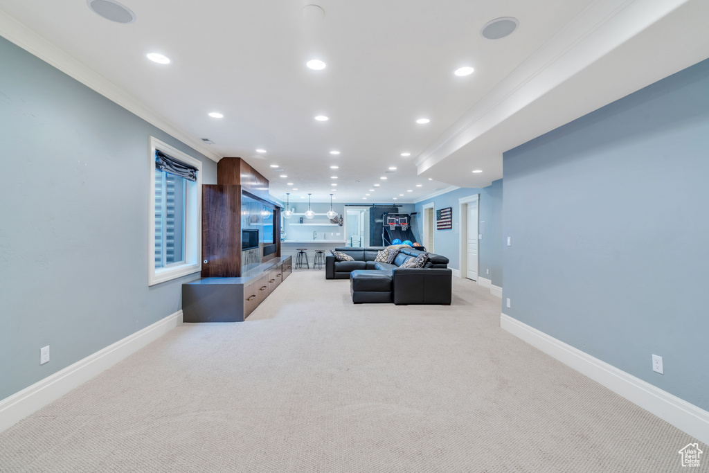 Carpeted living room with ornamental molding