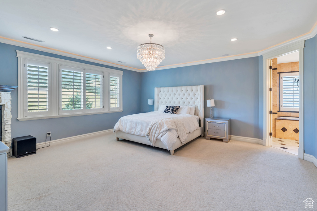 Bedroom with light carpet, multiple windows, and ornamental molding