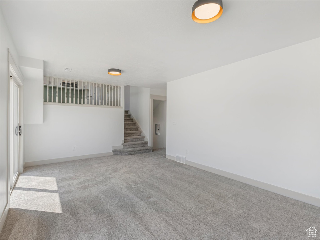 Spare room with light colored carpet