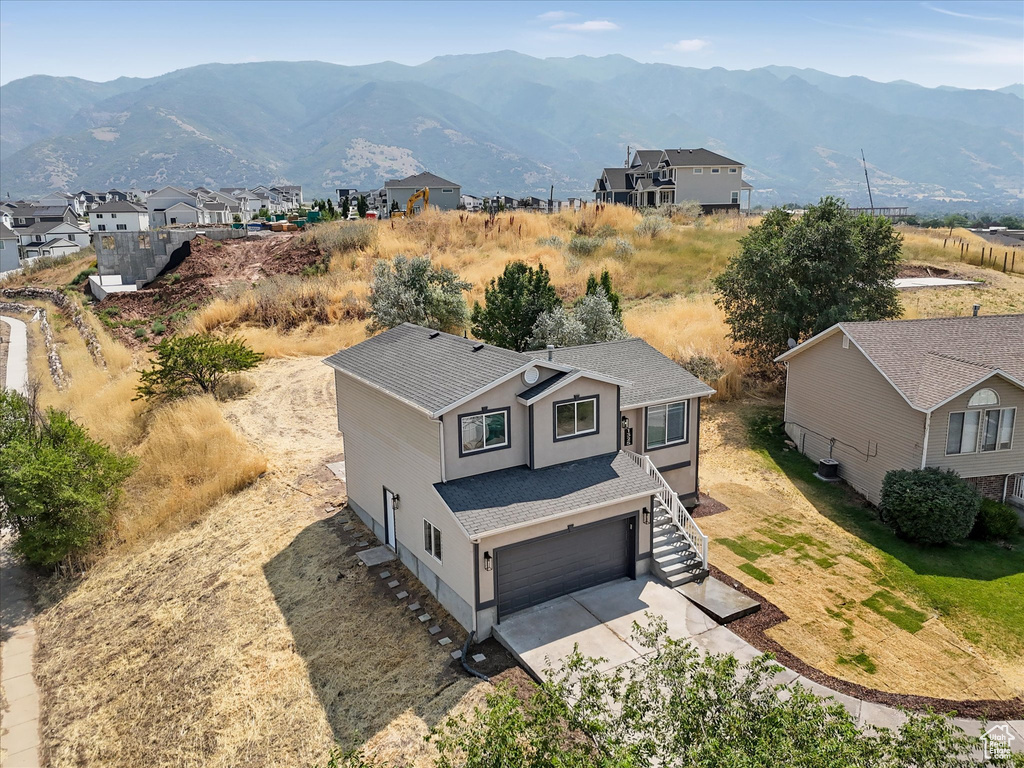 Exterior space with a mountain view and a garage