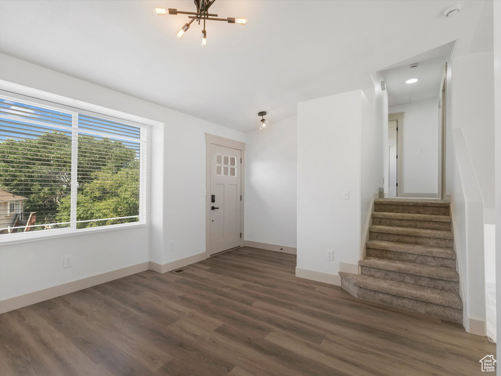 Entrance foyer featuring an inviting chandelier and hardwood / wood-style floors