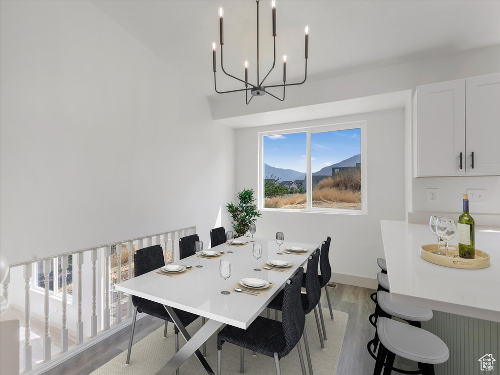 Dining area featuring light hardwood / wood-style flooring and a chandelier