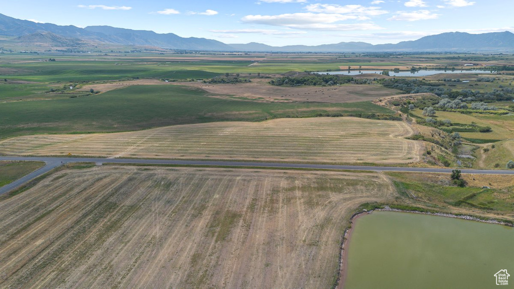 Birds eye view of property featuring a water and mountain view and a rural view