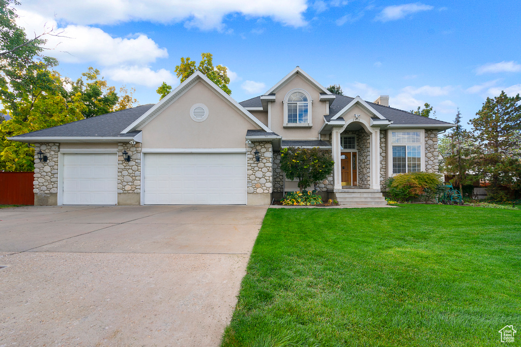 Front facade with a garage and a front lawn