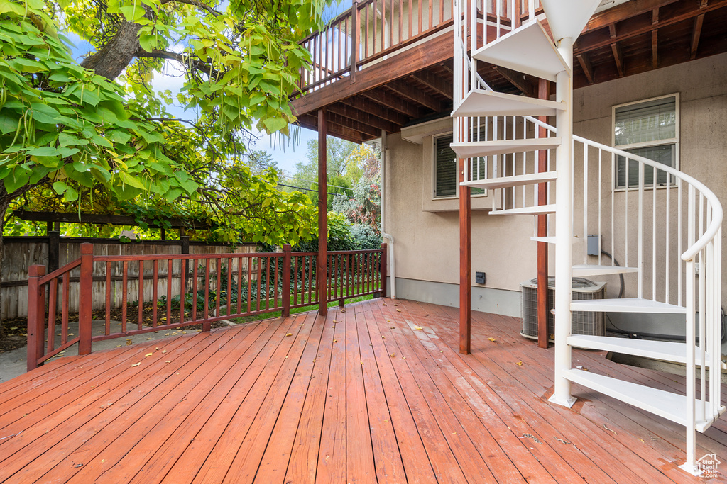 Wooden deck featuring central air condition unit